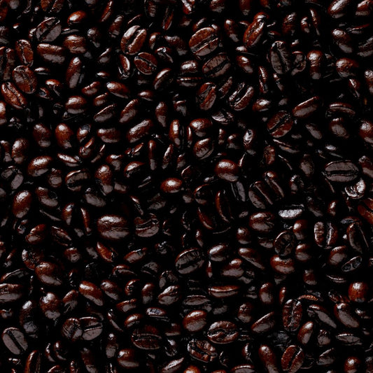 A close-up image of roasted coffee beans showing a dark, oily texture indicative of a French roast level.