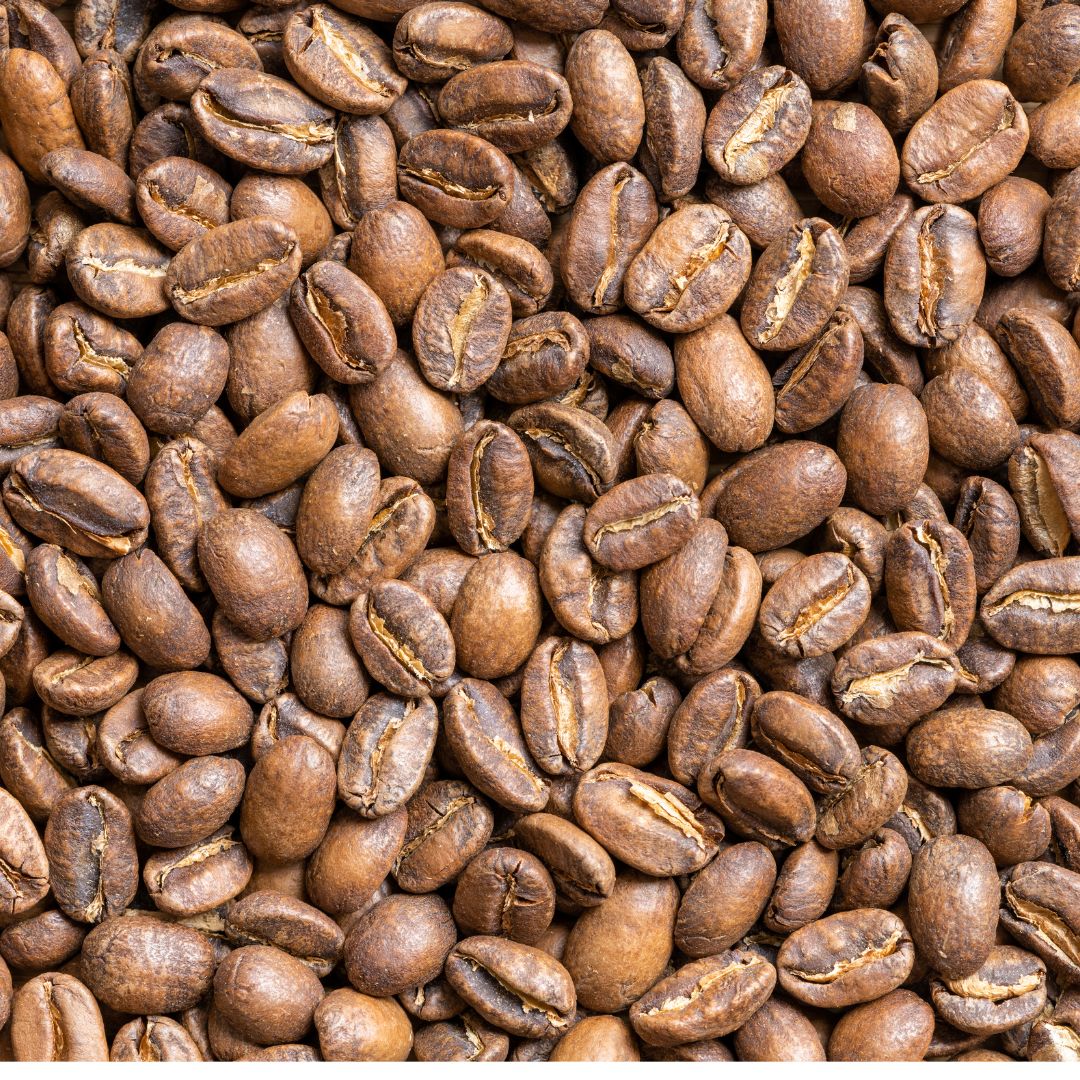 A close-up image of whole bean coffee, showcasing the texture and color of the beans at a city roast.