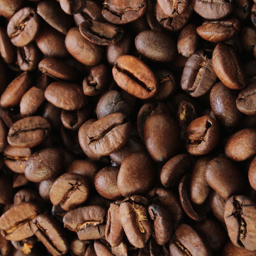 A close-up image of roasted 3rd wave coffee beans at a full city roast.